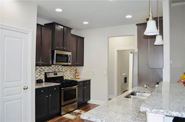 a living room with furniture a fireplace and a chandelier