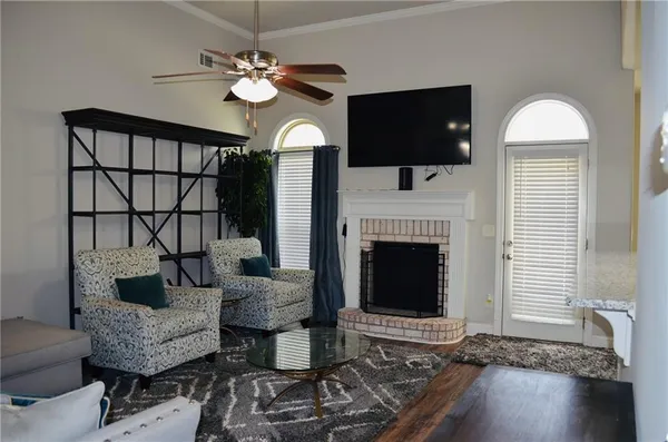 a view of a livingroom with a fireplace and window