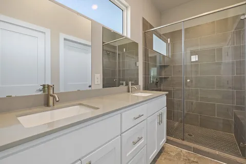 a bathroom with a granite countertop sink mirror and double
