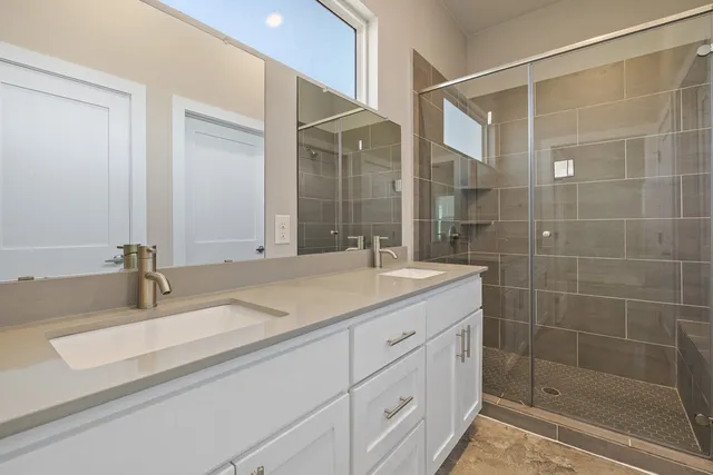 a bathroom with a granite countertop sink mirror and double
