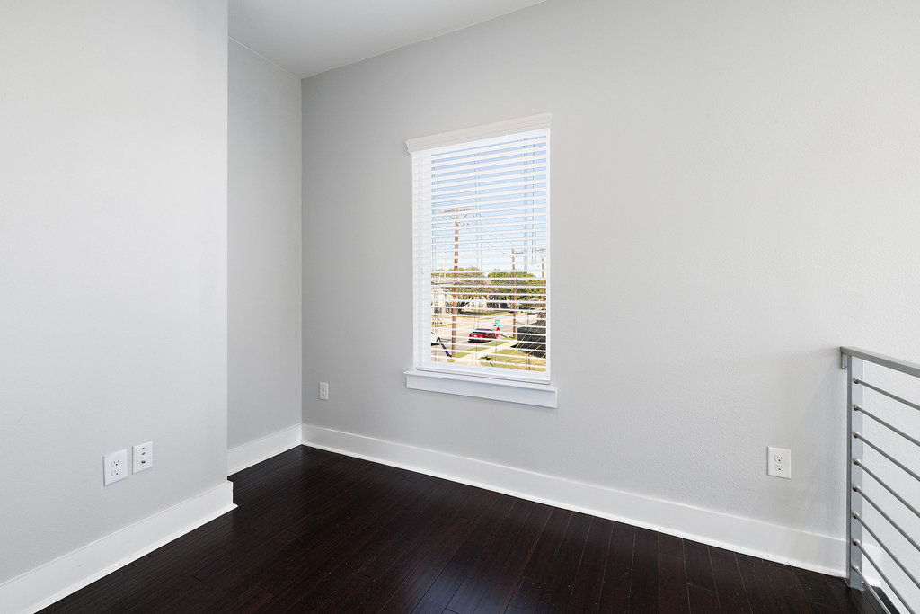 6301 Santos Street, Unit A Austin, TX 78741 - Photo 23 of 37 an empty room with wooden floor and windows