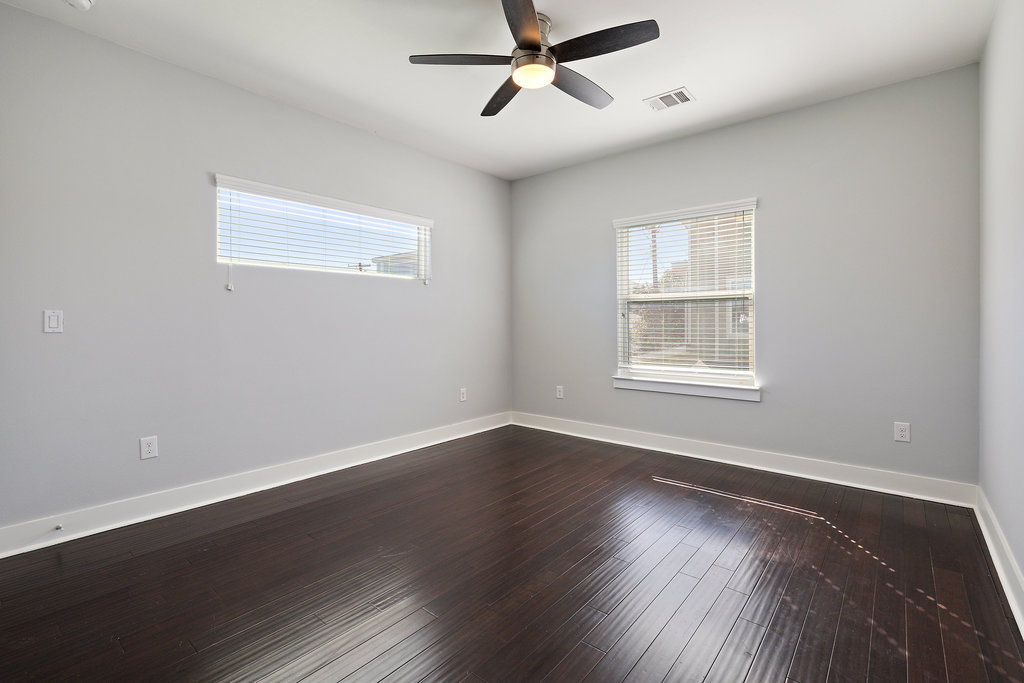 6301 Santos Street, Unit A Austin, TX 78741 - Photo 25 of 37 a view of an empty room with wooden floor and a window