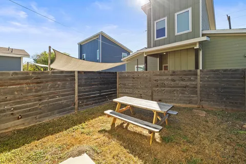 a wooden bench sitting in front of a building