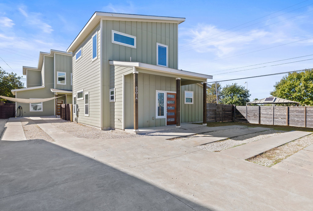 6301 Santos Street, Unit A Austin, TX 78741 - Photo 34 of 37 a front view of a house with a yard and garage