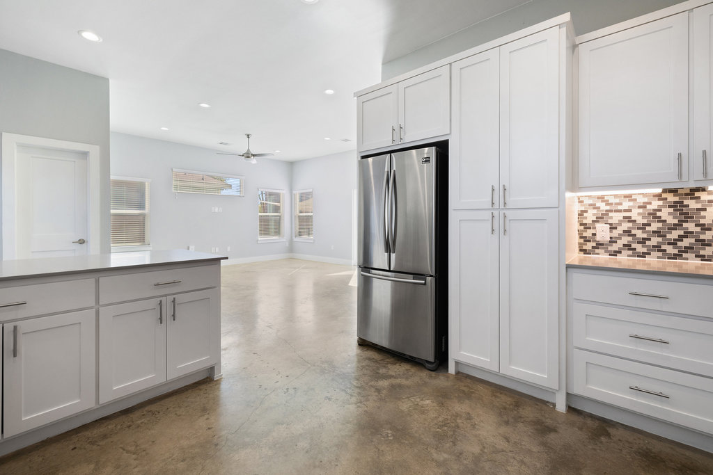6301 Santos Street, Unit A Austin, TX 78741 - Photo 10 of 37 a kitchen with white cabinets and refrigerator