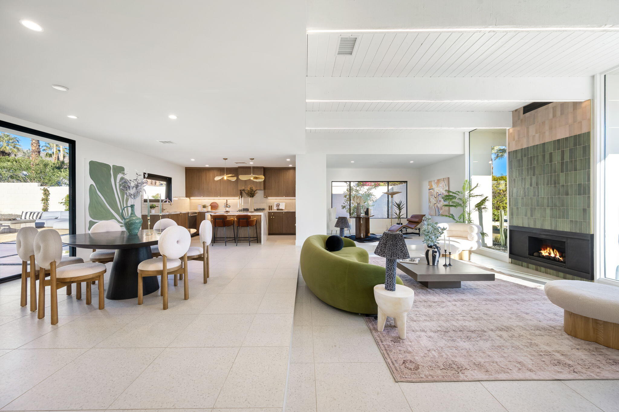 71459 Halgar Road Rancho Mirage, CA 92270 - Photo 22 of 46 a living room with furniture dining table a fireplace and a large window