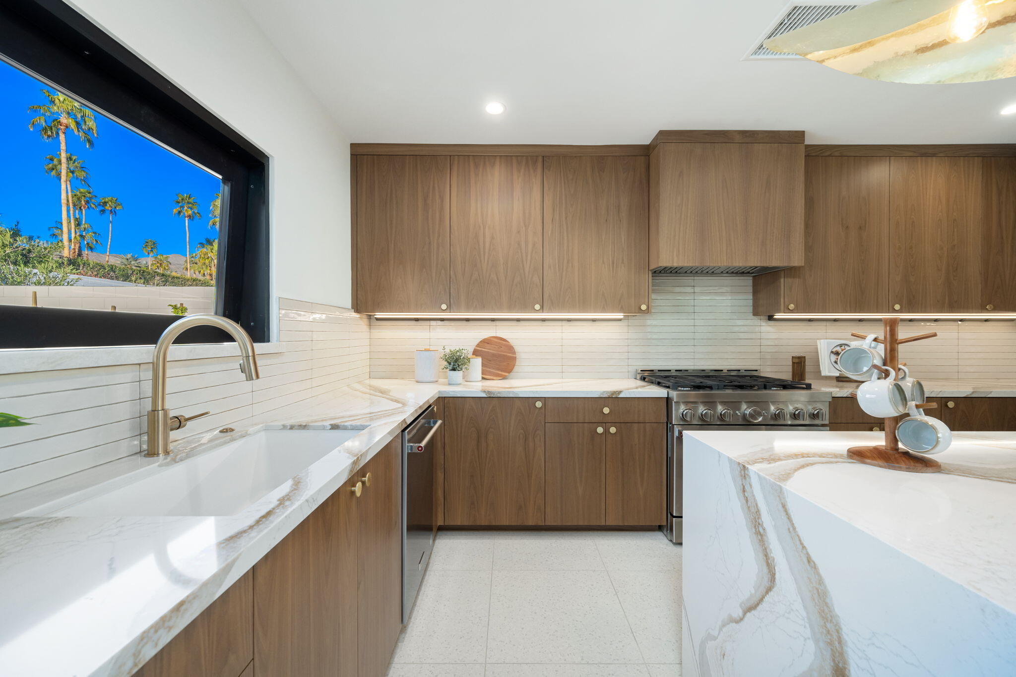71459 Halgar Road Rancho Mirage, CA 92270 - Photo 28 of 46 a kitchen with stainless steel appliances a sink stove and cabinets