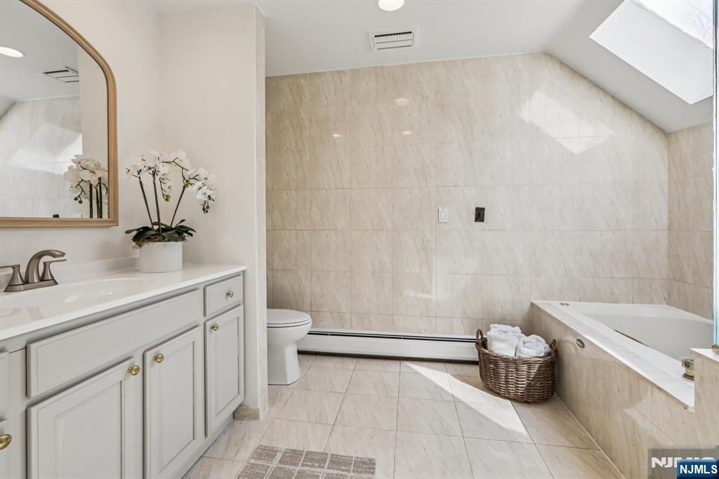 11 Carlough Road Upper Saddle River, NJ 07458 - Photo 30 of 41 a bathroom with a sink a toilet and shower