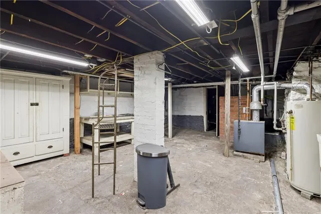 a view of a room with wooden floor and mirror