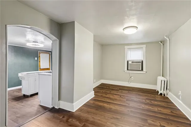 a view of a room with wooden floor
