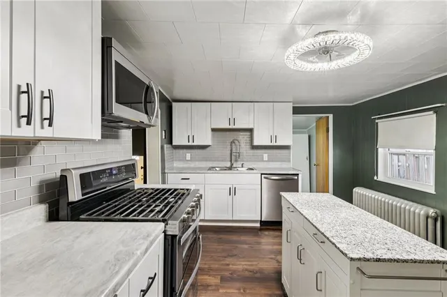a bathroom with a sink toilet and a mirror