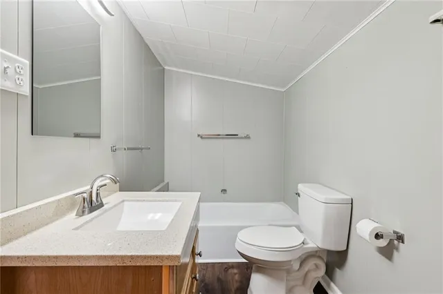 a view of a hallway with wooden floor and entryway
