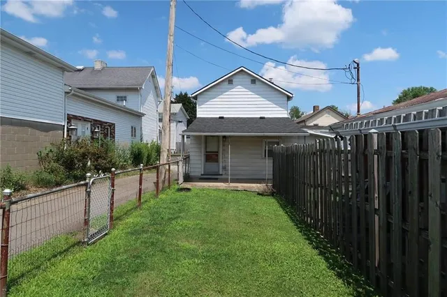 a view of a house with wooden fence