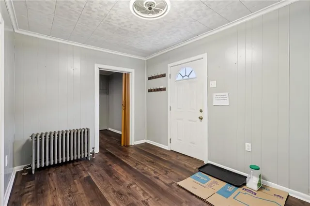 a view of a livingroom with wooden floor and door