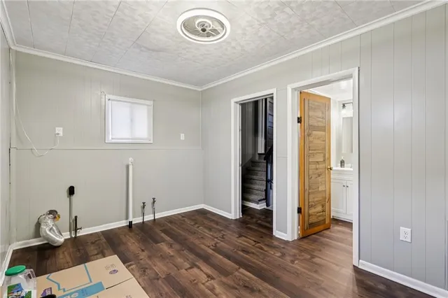 an empty room with wooden floor and entrance