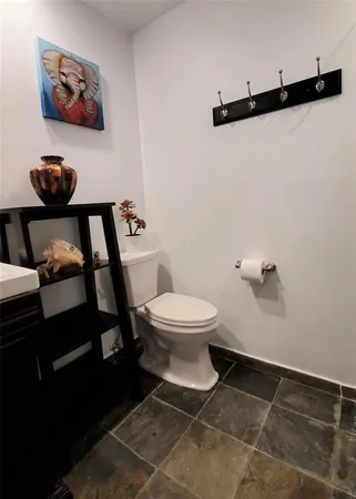 a bathroom with a toilet and a mirror