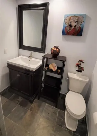 a bathroom with a sink toilet and mirror