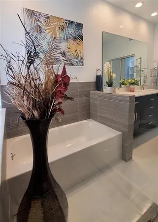 a bathroom with a bathtub and a mirror