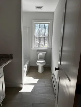 a view of room with wooden floor and window