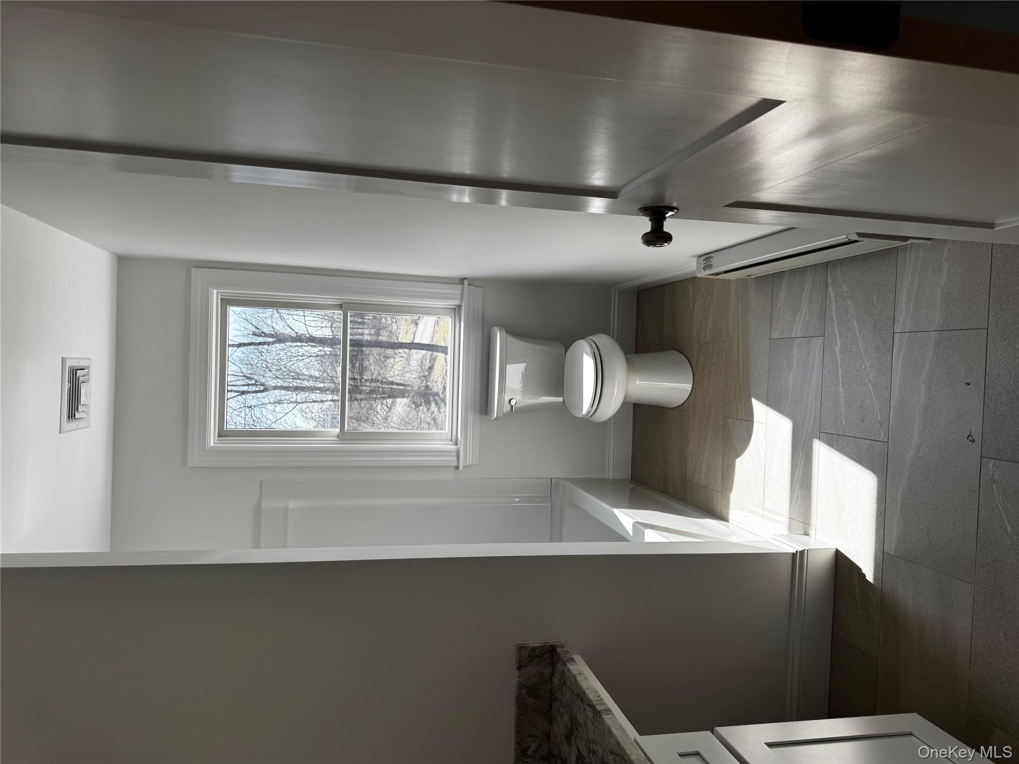 7 Tulip Road Mahopac, NY 10541 - Photo 11 of 32 a bathroom with a toilet sink and window