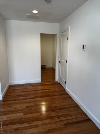 a view of a refrigerator in kitchen and wooden floor