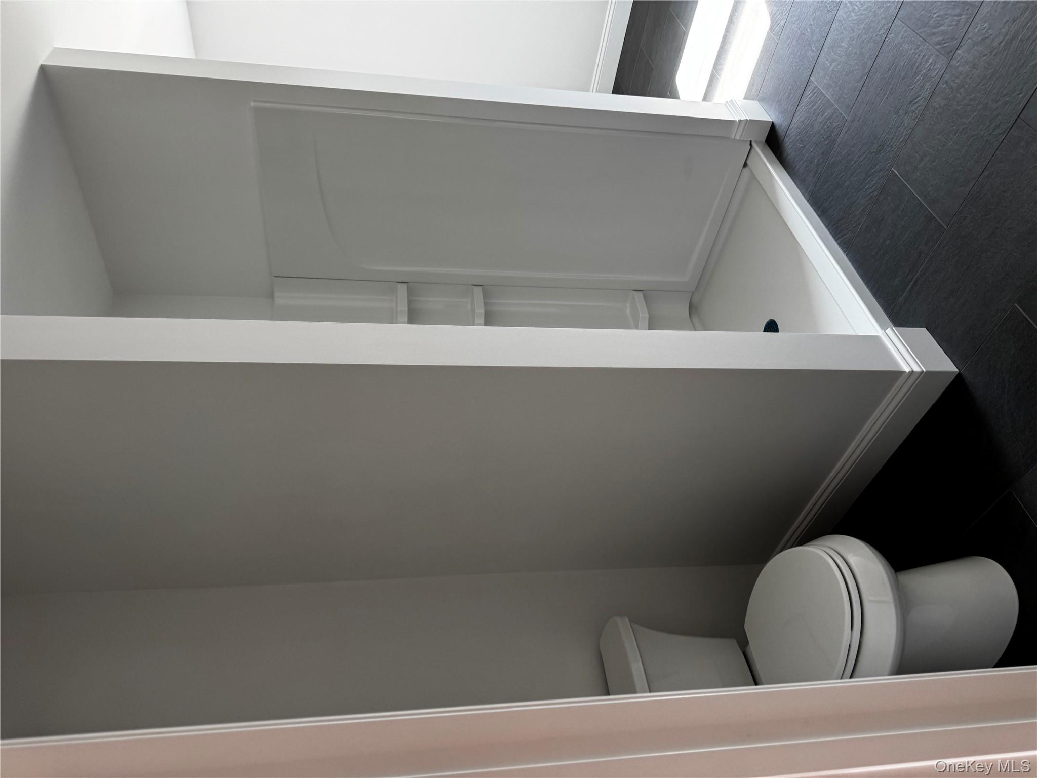 7 Tulip Road Mahopac, NY 10541 - Photo 20 of 32 a white toilet sitting next to a shower