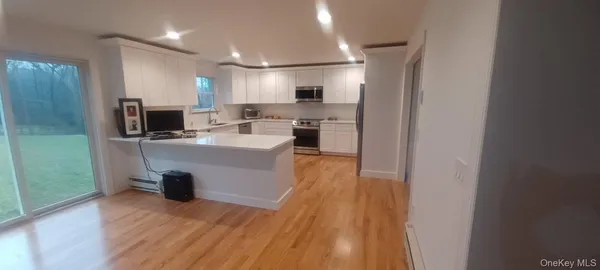 a kitchen with stainless steel appliances granite countertop a stove a refrigerator and a sink