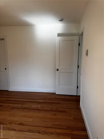 a view of room with wooden floor and window
