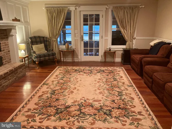a living room with a large window and a bed