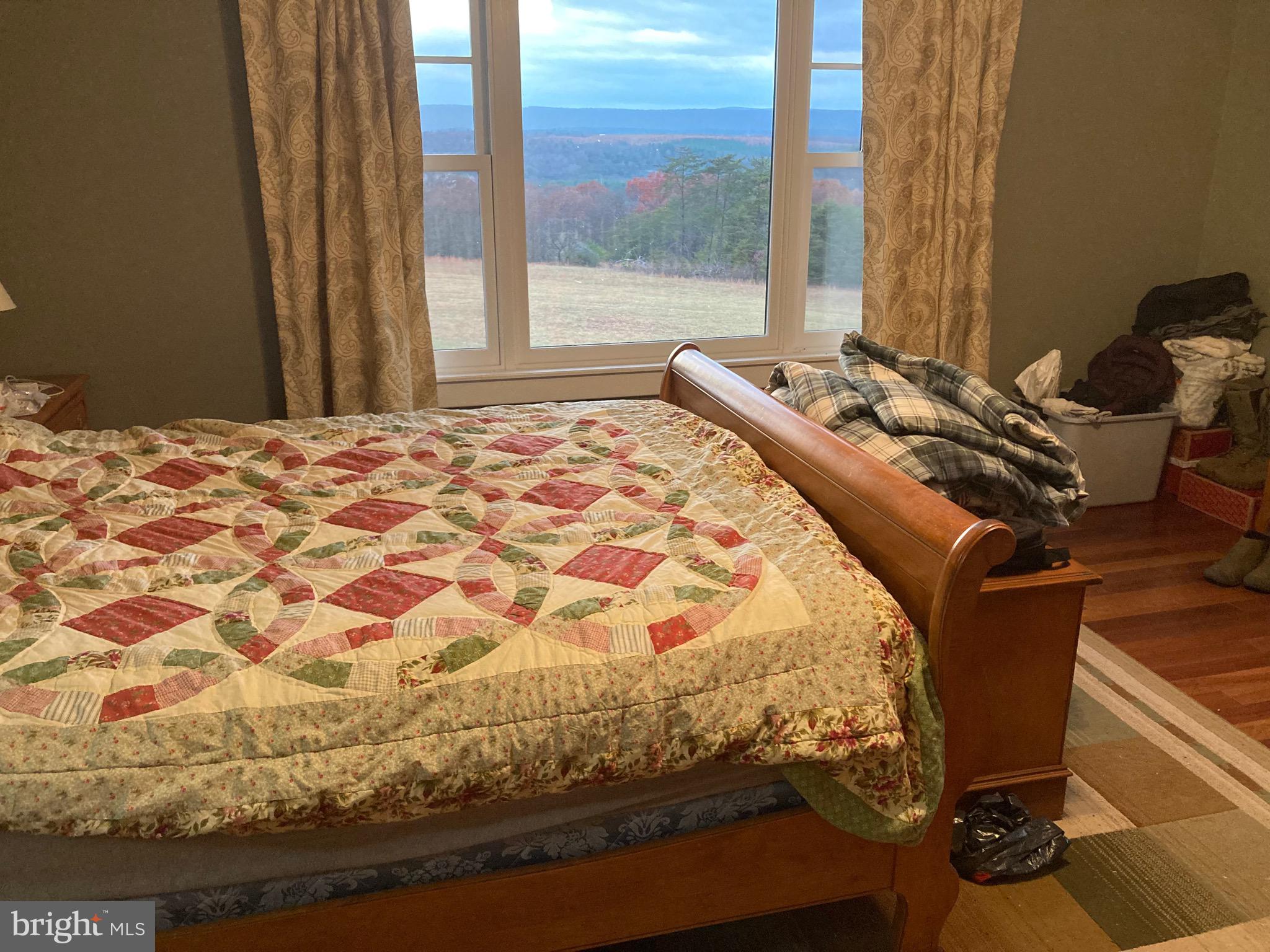 8124 Cromwell Church Road Hustontown, PA 17229 - Photo 30 of 61 a bed sitting in a bedroom next to a window