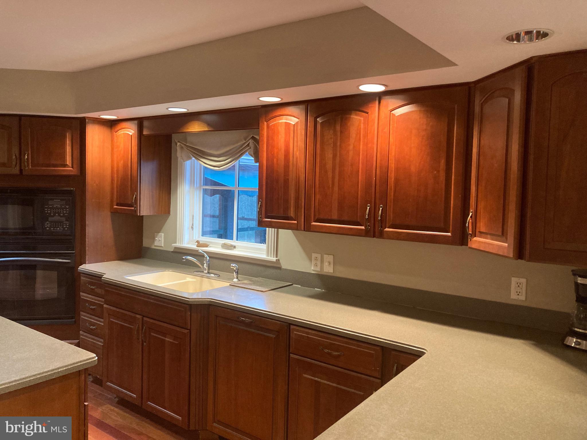 8124 Cromwell Church Road Hustontown, PA 17229 - Photo 6 of 61 a kitchen with stainless steel appliances granite countertop wooden cabinets a sink and a large window