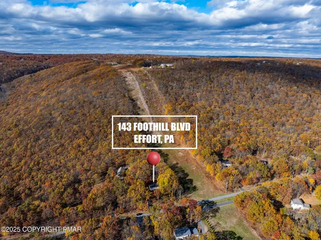 an empty room with windows and chandelier fan