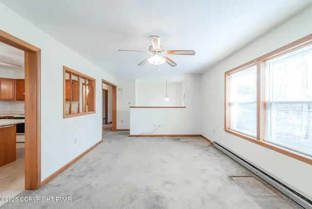 a view of a backyard with a large tree and wooden fence
