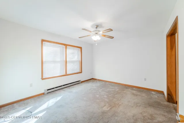a view of a house with a big yard and large trees
