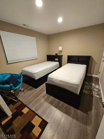 a bedroom with two beds and a night stand