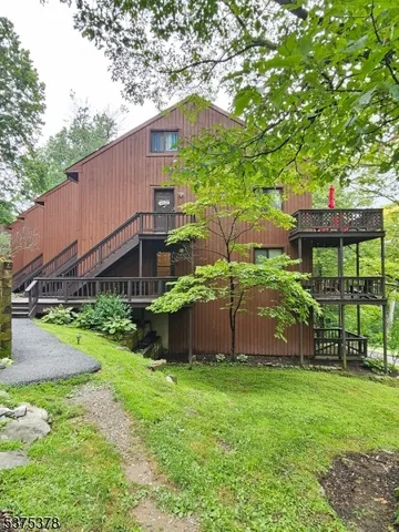a view of a house with a yard and a garden