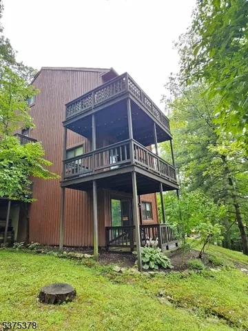 a view of a house with a small yard and plants