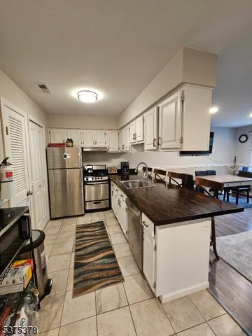 a kitchen with stainless steel appliances granite countertop a sink and a stove
