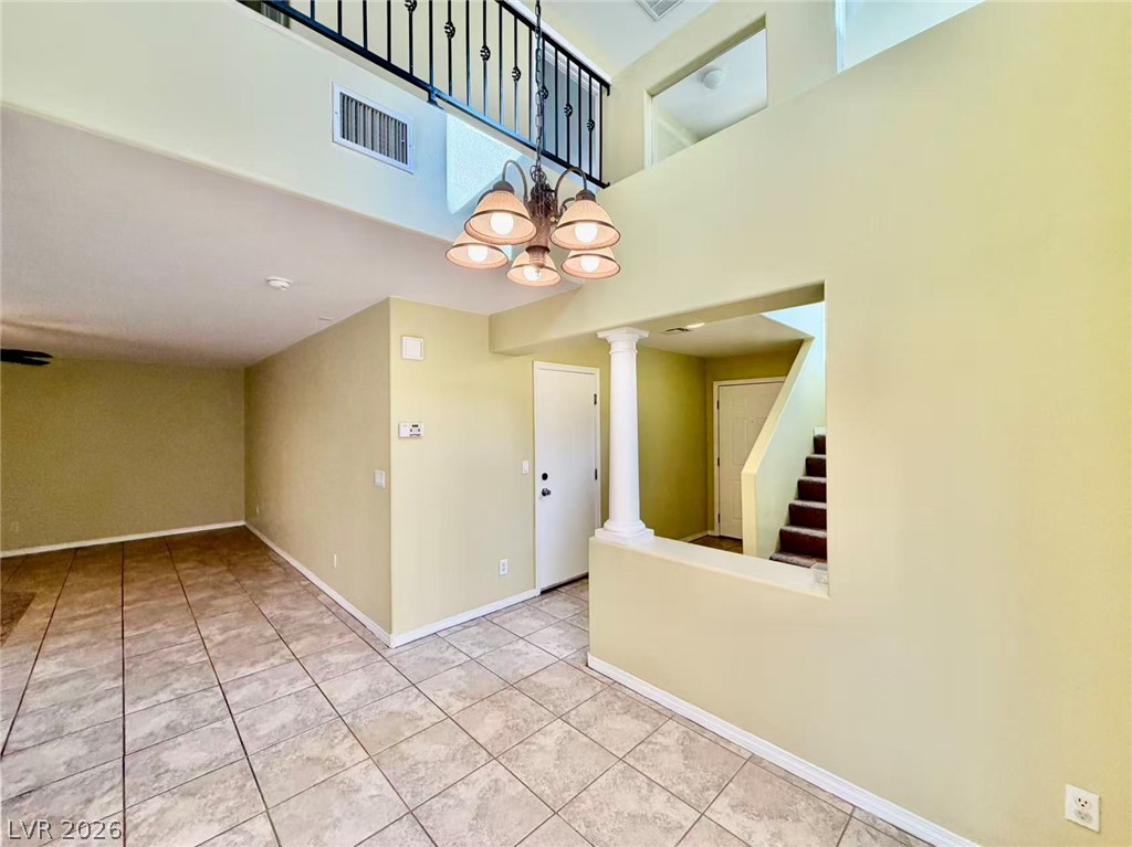 7326 Dicentra Road Las Vegas, NV 89113 - Photo 2 of 18 Tiled flooring and soaring multi-level ceilings define this welcoming entry area.