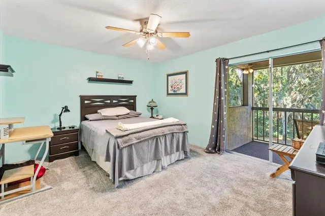 a bedroom with a bed a chandelier and large window