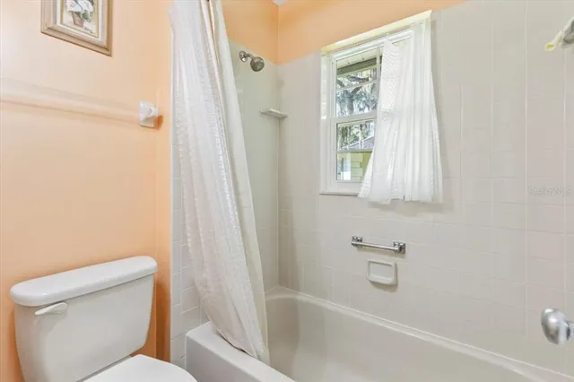 a bathroom with a toilet and a bathtub