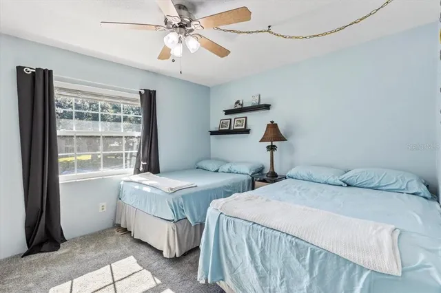 a bedroom with two beds and a window