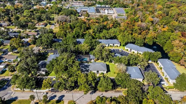 an aerial view of residential house with swimming pool and green space