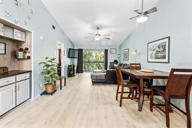 a view of a dining room with furniture and a chandelier
