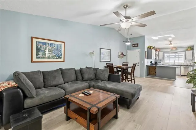 a living room with furniture and kitchen view