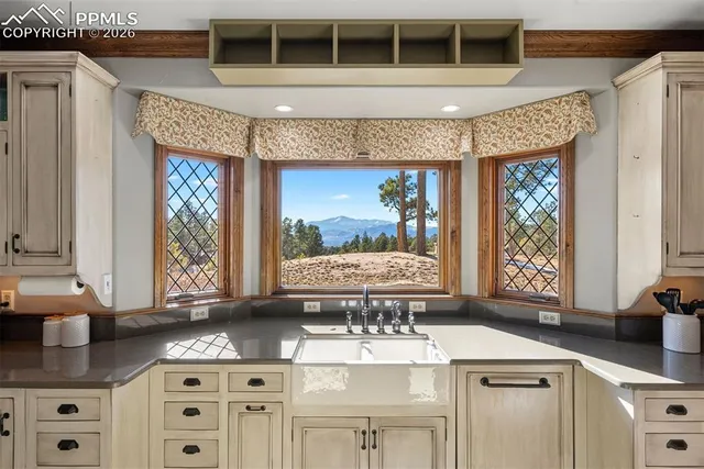 a kitchen with a sink a stove and cabinets