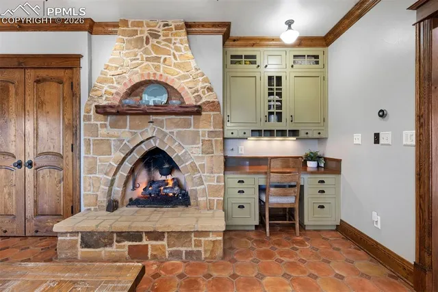 a living room with furniture a fireplace and a chandelier