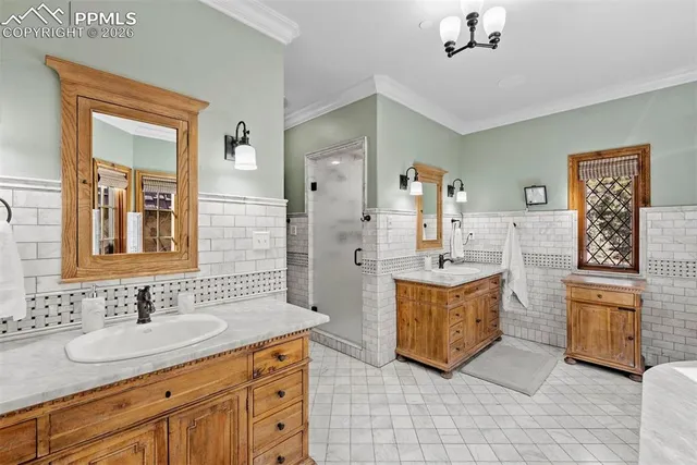 a bathroom with a granite countertop double vanity sink a mirror and a