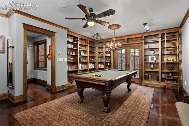 a living room with furniture pool table and window