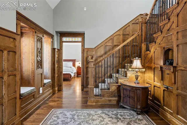 a view of a hallway with wooden floor and furniture